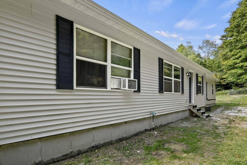 2792 Hancock Road Hancock, MA 01237 - Photo 26 of 38 a view of a house with a large window and wooden fence