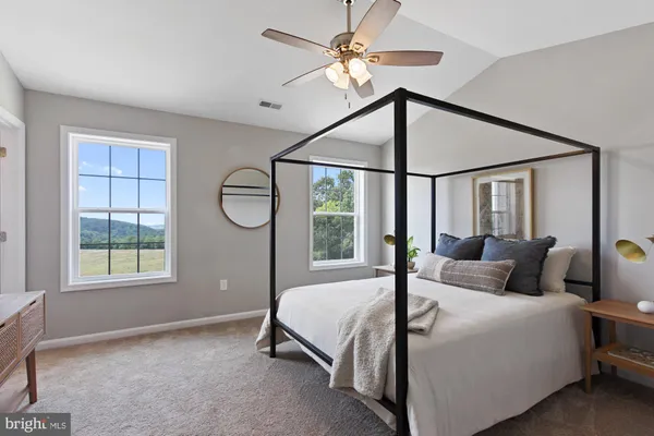 a bedroom with a large bed and a chandelier