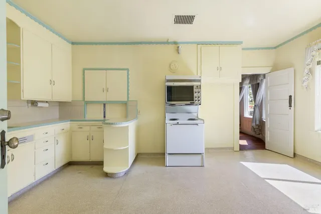 a kitchen with stainless steel appliances a refrigerator sink and cabinets