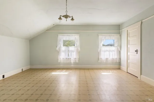 a view of a room with wooden floor and white walls