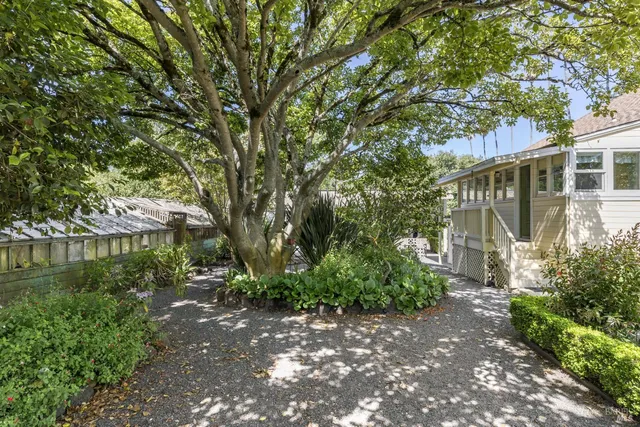 a view of a patio with a yard chairs and iron stairs