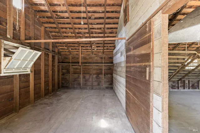 a view of a porch with wooden floor and roof