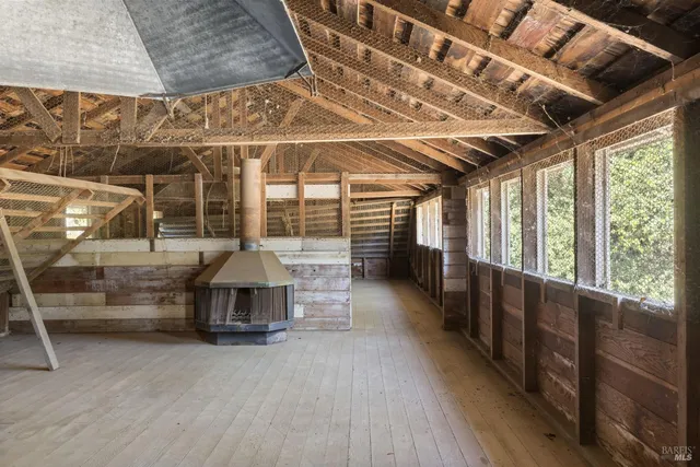 a view of an empty room with wooden walls