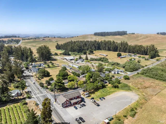an aerial view of residential house with outdoor space and street view