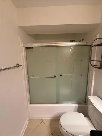 a white bath tub sitting next to a white sink and a shower
