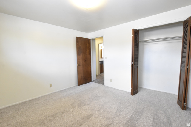 290 West 600 North Logan, UT 84321 - Photo 32 of 45 Bedroom featuring light-toned carpeting, white walls, and a ceiling-mounted light fixture
