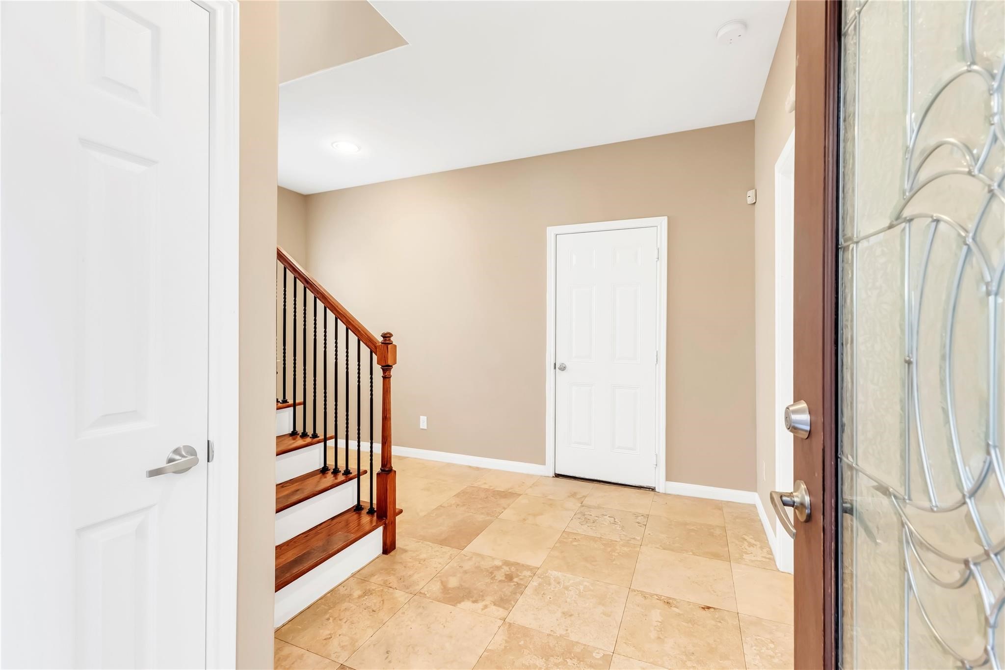 934 West 26th Street, Unit B Houston, TX 77008 - Photo 5 of 33 The welcoming entryway features tile flooring and a staircase leading to the main living areas.