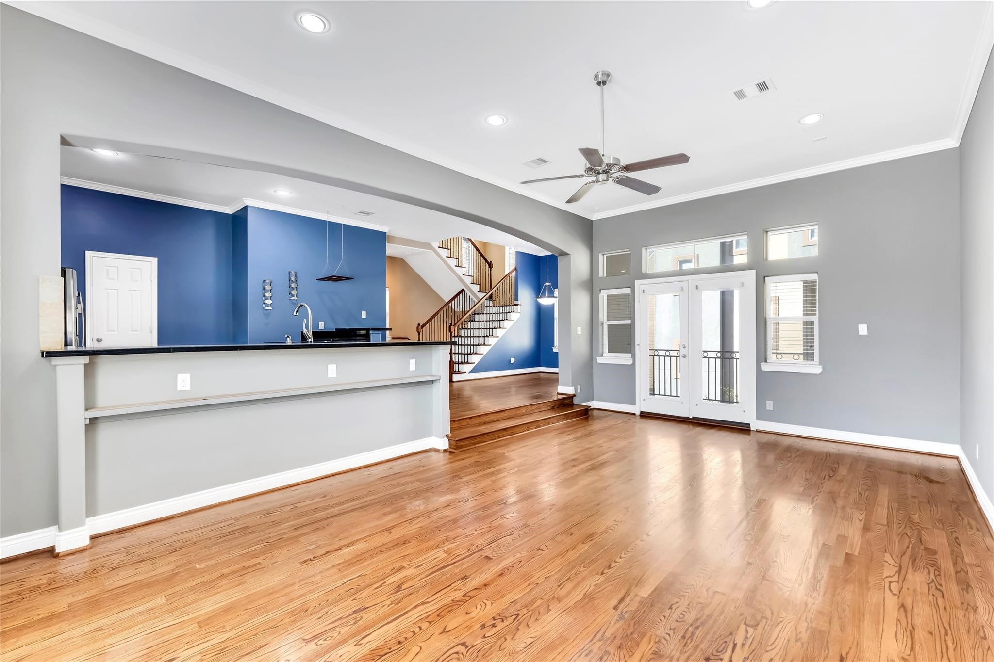 934 West 26th Street, Unit B Houston, TX 77008 - Photo 8 of 33 a view of a kitchen with wooden floor and a ceiling fan
