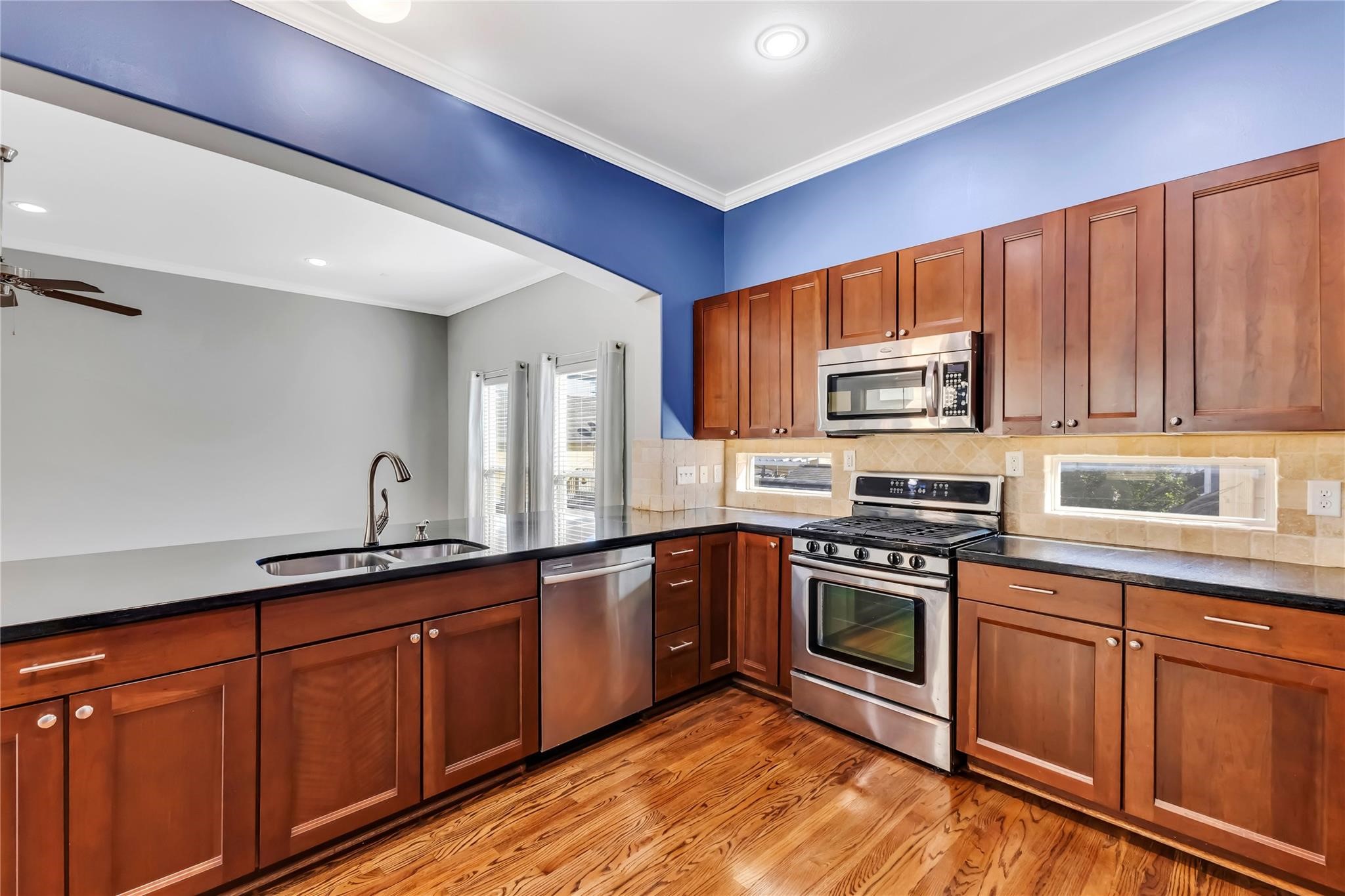 934 West 26th Street, Unit B Houston, TX 77008 - Photo 9 of 33 a kitchen with stainless steel appliances granite countertop a stove sink and cabinets