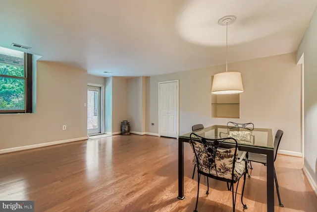 a view of a livingroom with furniture window and wooden floor