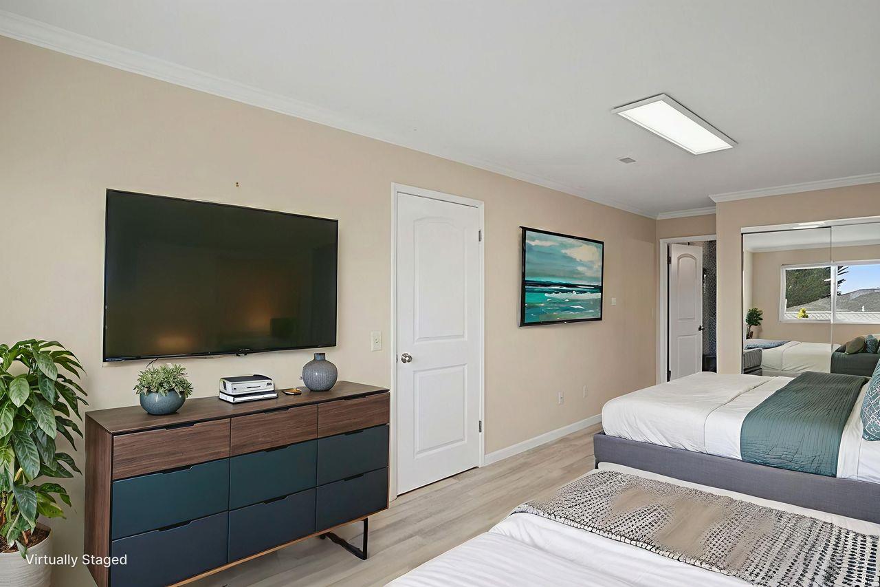 701 Archer Street Monterey, CA 93940 - Photo 18 of 39 a bedroom with a bed and a flat screen tv