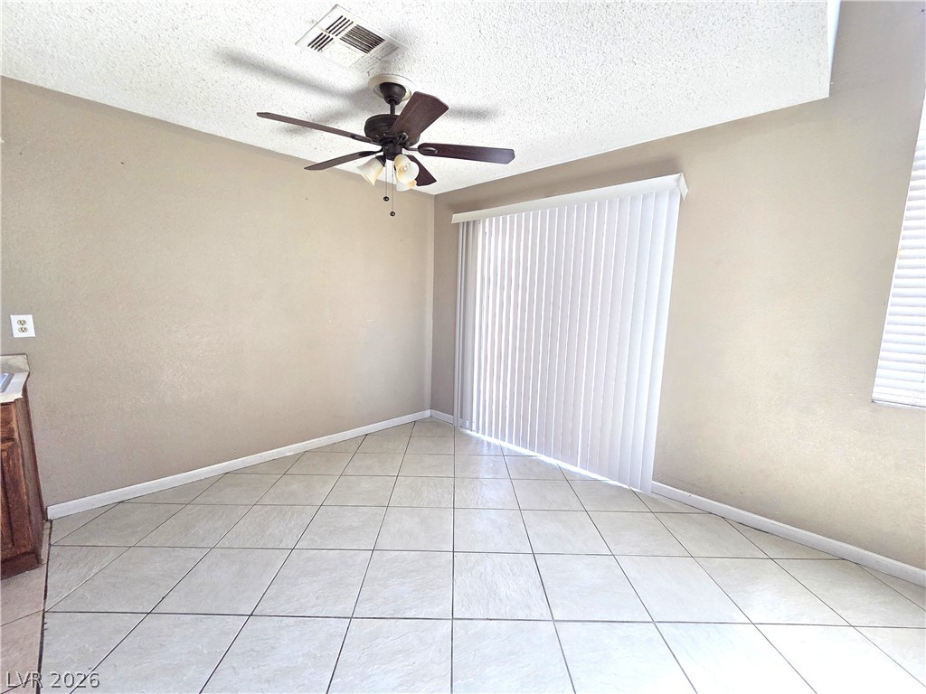 2882 Sandyfalls Way Las Vegas, NV 89142 - Photo 5 of 18 The generously sized dining space features tiled flooring and an overhead fan for comfort.
