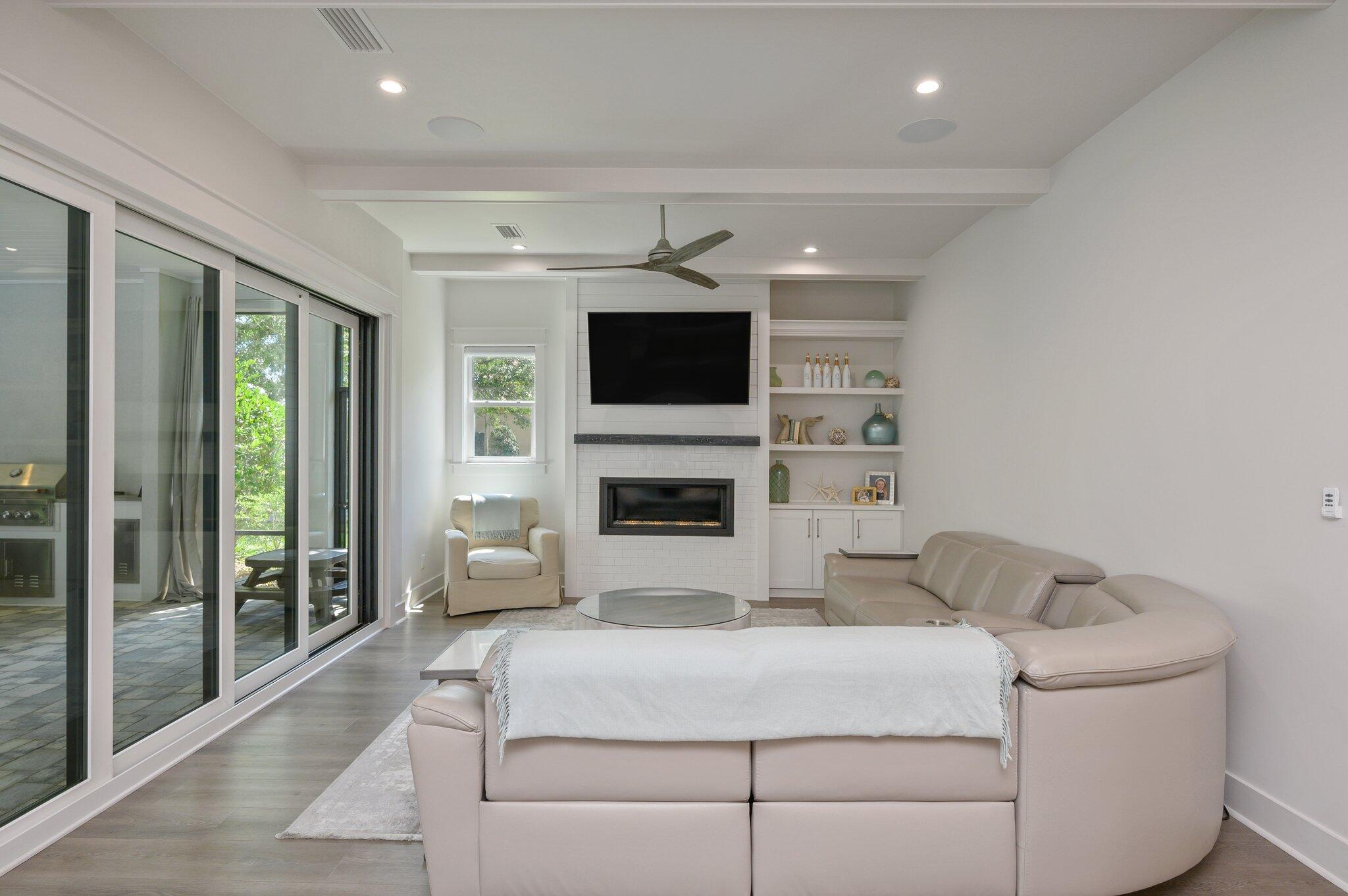 3278 Burnt Pine Circle Miramar Beach, FL 32550 - Photo 65 of 100 a living room with furniture a flat screen tv and a fireplace