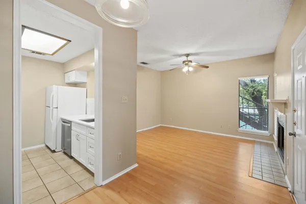 a kitchen with granite countertop a sink a stove and refrigerator