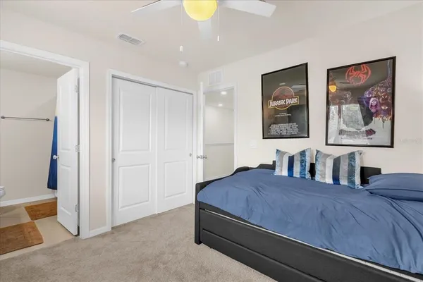 a bedroom with a bed and a chandelier