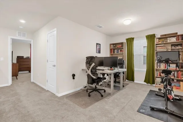 a view of a workspace with furniture and a bedroom