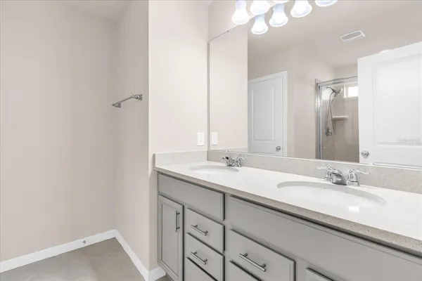 a bathroom with a sink double vanity and a mirror