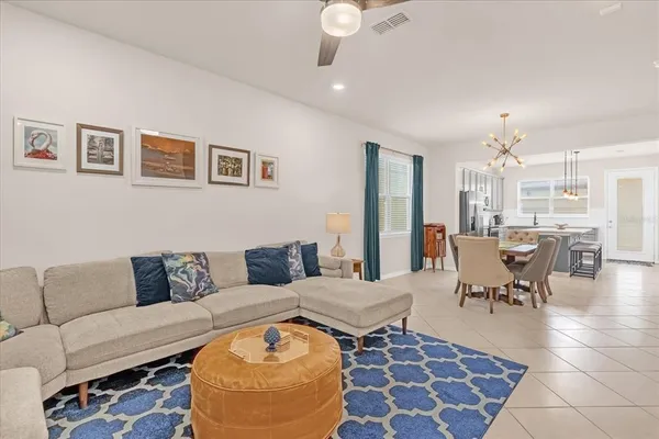 a living room with furniture and a dining table