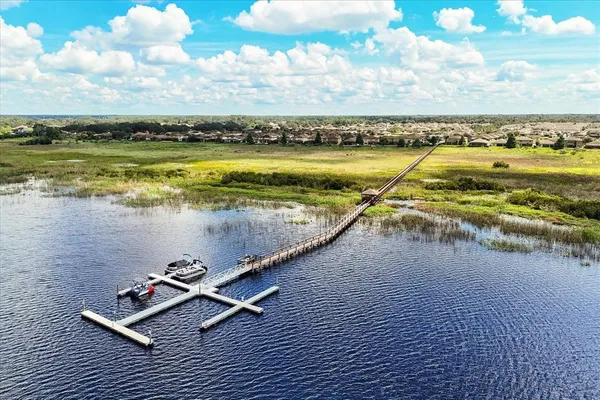 a view of a lake with houses in back