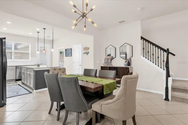 a view of a dining room with furniture and a chandelier