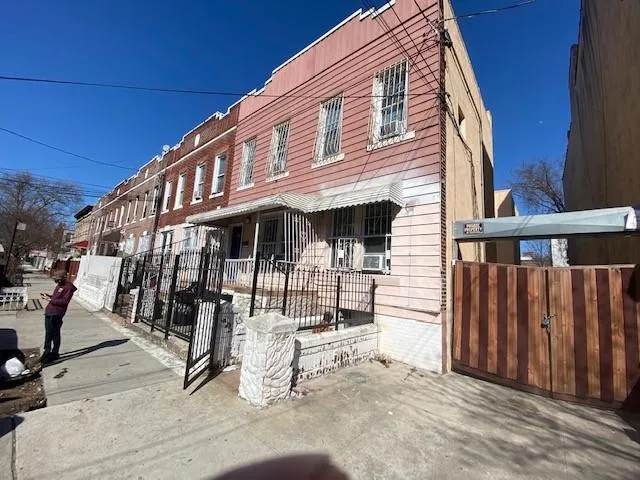 a view of a house with wooden fence