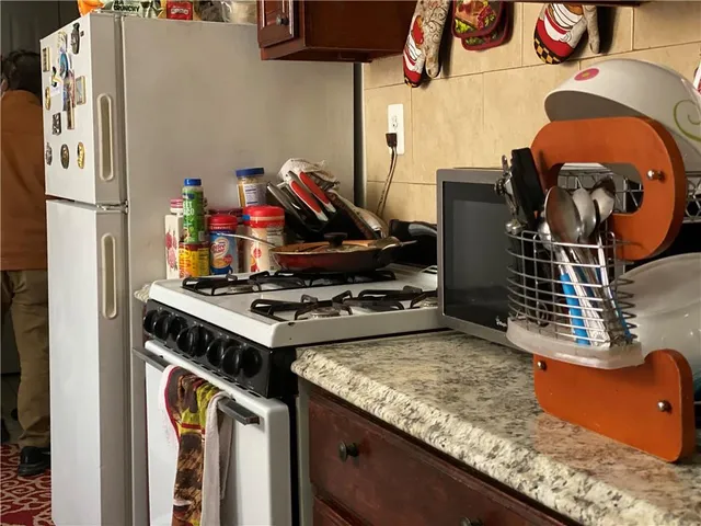 a stove top oven sitting inside of a kitchen