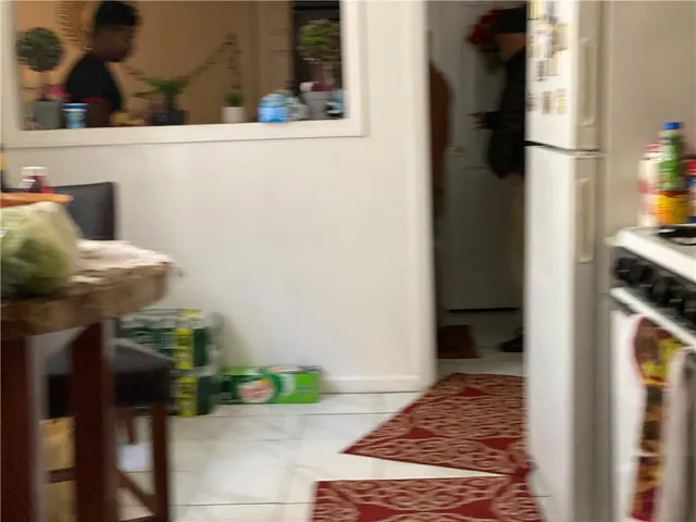 a kitchen with a refrigerator and a stove