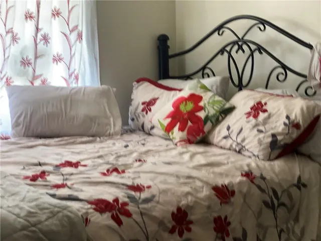 a bedroom with a bed and a painting on the wall