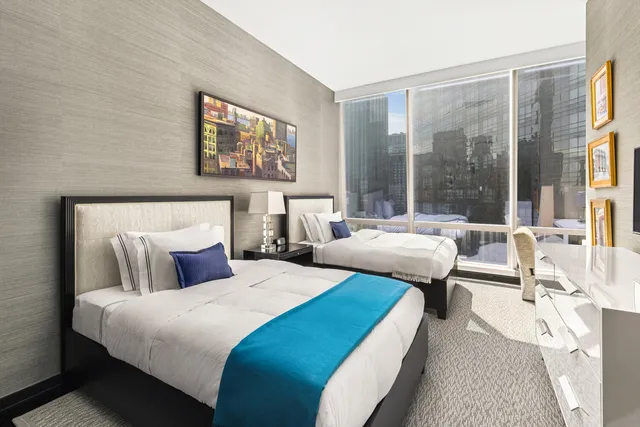 a bathroom with a granite countertop double vanity sink a mirror and shower