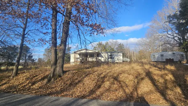 a view of a yard with wooden fence