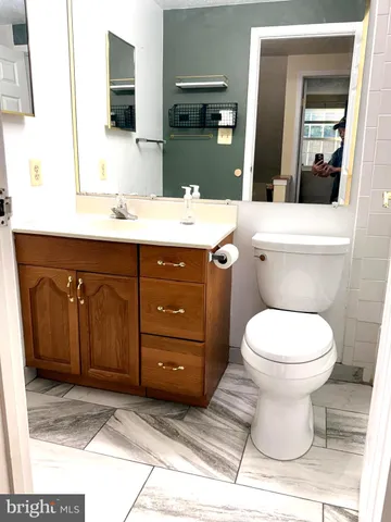 a bathroom with a sink toilet and mirror