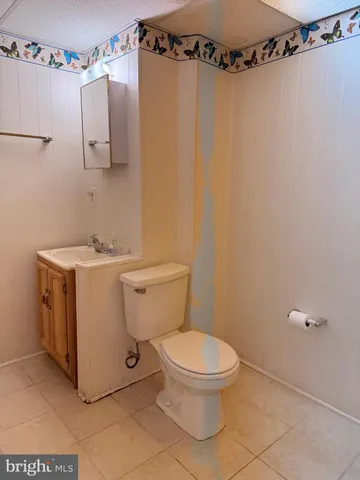 a white toilet sitting next to a bathroom sink