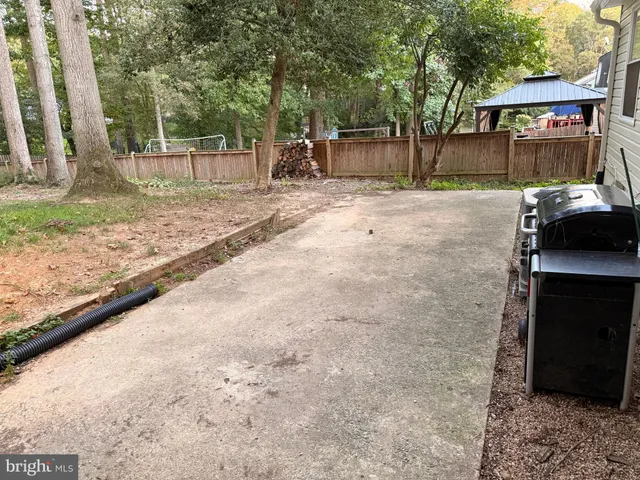 a backyard of a house with barbeque oven