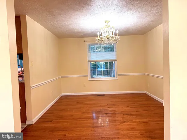 a view of a room with window and wooden floor