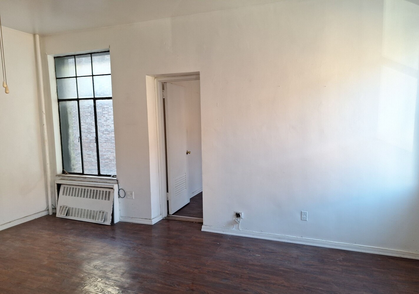 200 West 139th Street Manhattan, NY 10030 - Photo 17 of 24 an empty room with wooden floor and windows