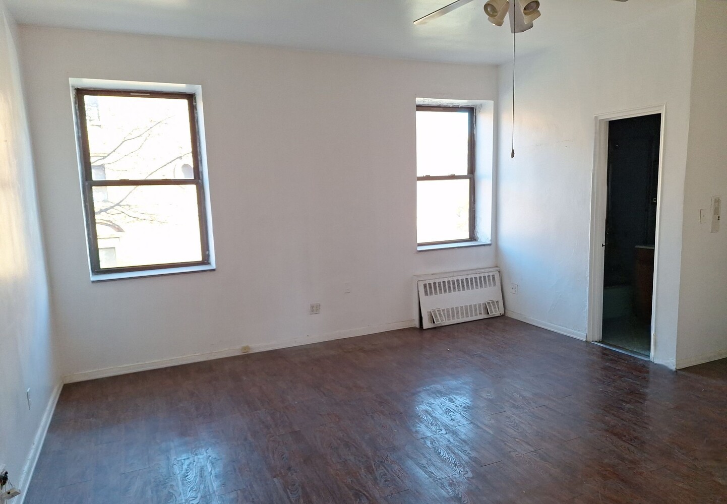 200 West 139th Street Manhattan, NY 10030 - Photo 18 of 24 an empty room with wooden floor and windows