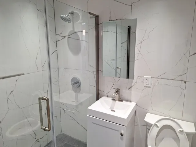 an empty room with wooden floor and window