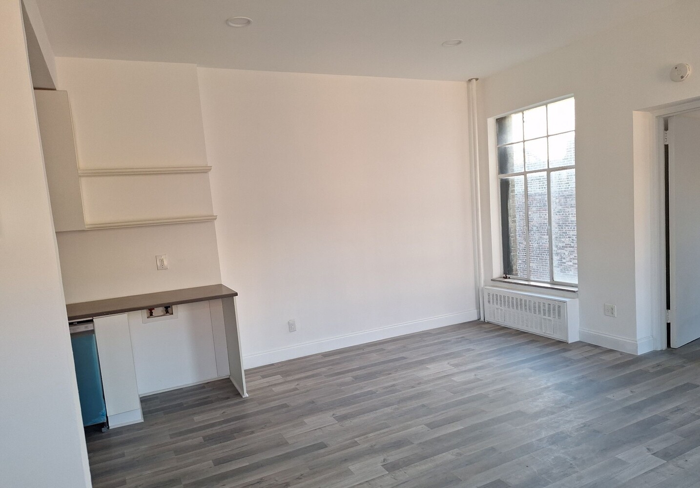200 West 139th Street Manhattan, NY 10030 - Photo 20 of 24 an empty room with wooden floor and window