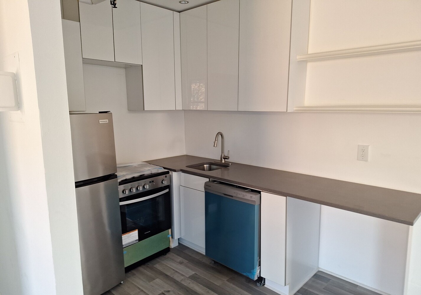 200 West 139th Street Manhattan, NY 10030 - Photo 21 of 24 a kitchen with stainless steel appliances granite countertop white cabinets and a stove