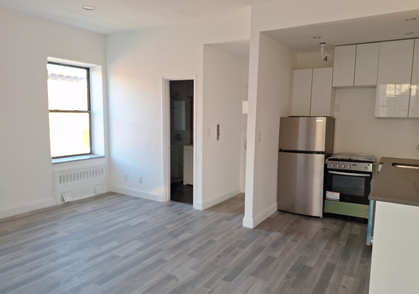 200 West 139th Street Manhattan, NY 10030 - Photo 22 of 24 a kitchen with a refrigerator and a stove top oven