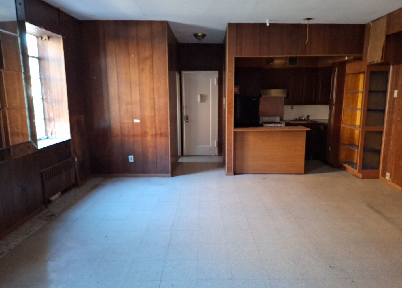 200 West 139th Street Manhattan, NY 10030 - Photo 6 of 24 a view of an empty room with a fireplace and a window