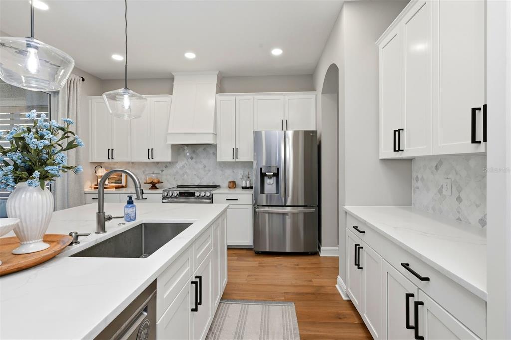 13912 Darchance Road Windermere, FL 34786 - Photo 18 of 49 a kitchen with kitchen island white cabinets and white appliances