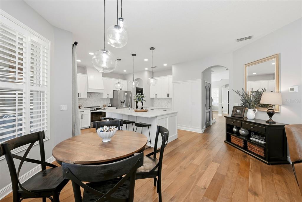 13912 Darchance Road Windermere, FL 34786 - Photo 24 of 49 a view of a dining room with furniture and wooden floor
