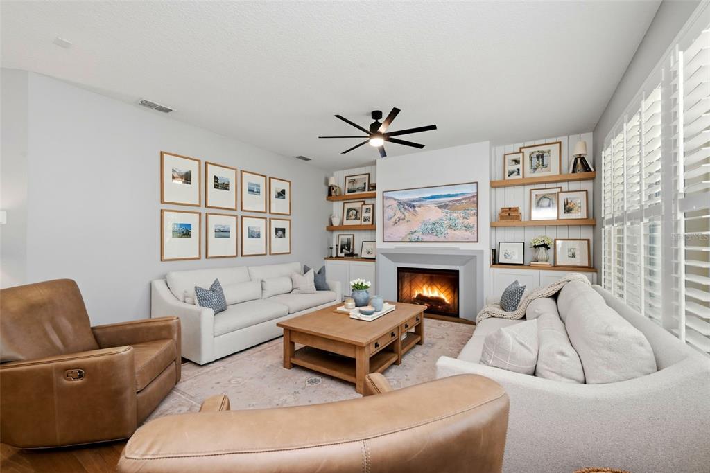 13912 Darchance Road Windermere, FL 34786 - Photo 26 of 49 a living room with furniture a fireplace and a large window