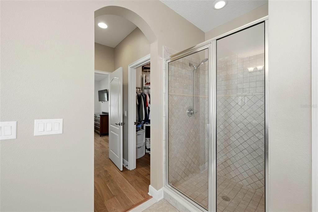 13912 Darchance Road Windermere, FL 34786 - Photo 40 of 49 a bathroom with a shower and a glass door