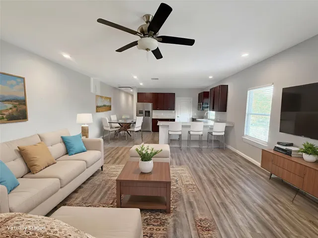 a living room with furniture and a flat screen tv
