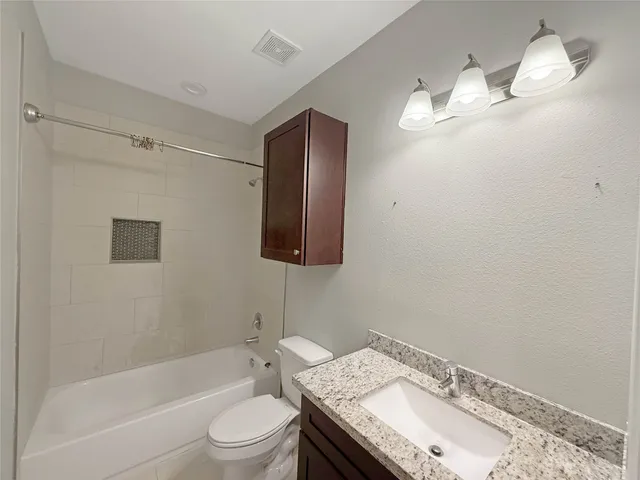 a bathroom with a sink a toilet and bathtub