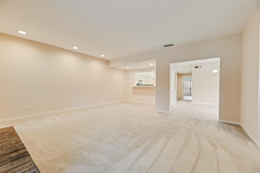 4988 Thunder Road Dallas, TX 75244 - Photo 5 of 32 Spacious room featuring a brick fireplace, neutral carpet, and recessed lighting