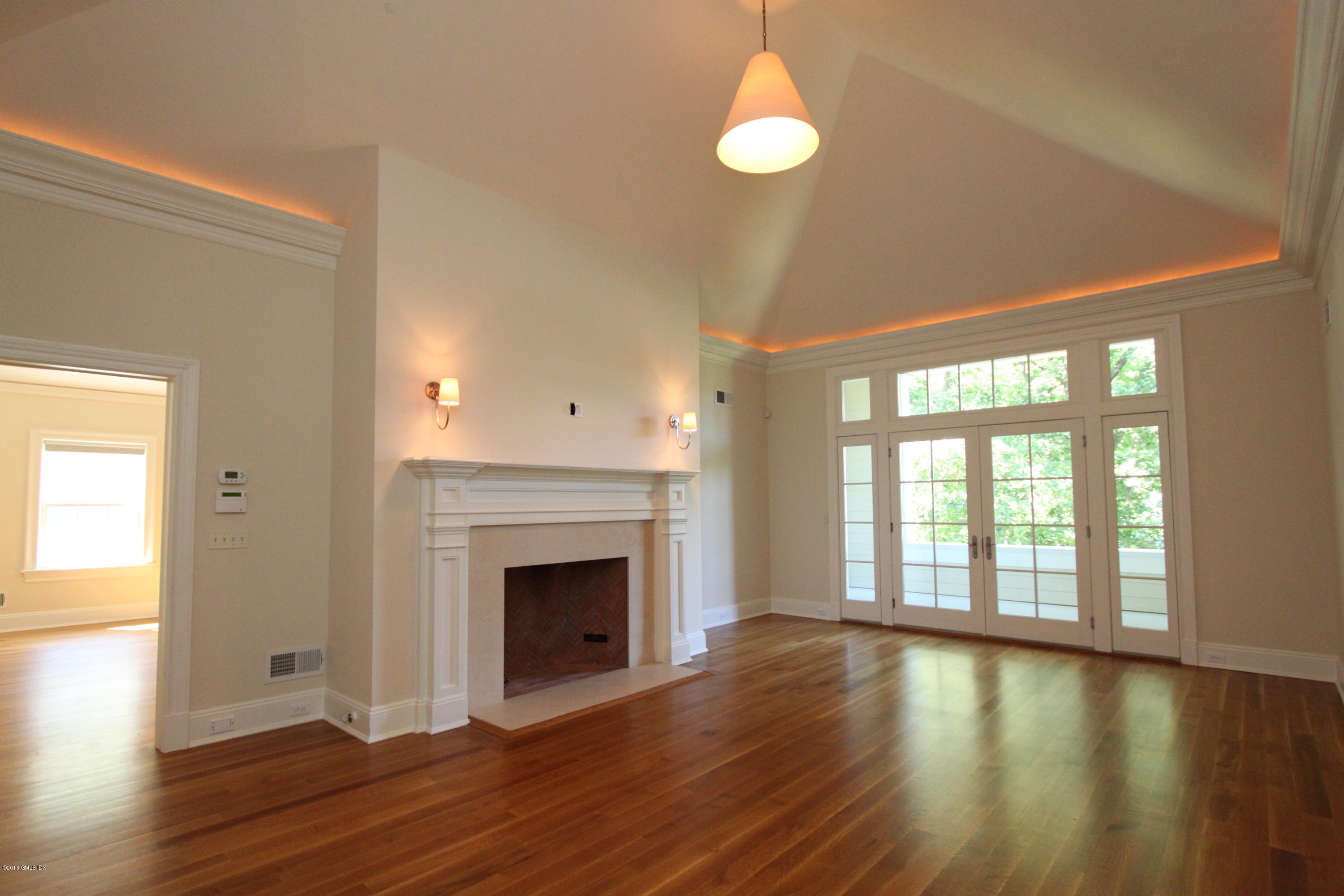 43 Burning Tree Road Greenwich, CT 06830 - Photo 15 of 24 a view of an empty room with wooden floor and a window