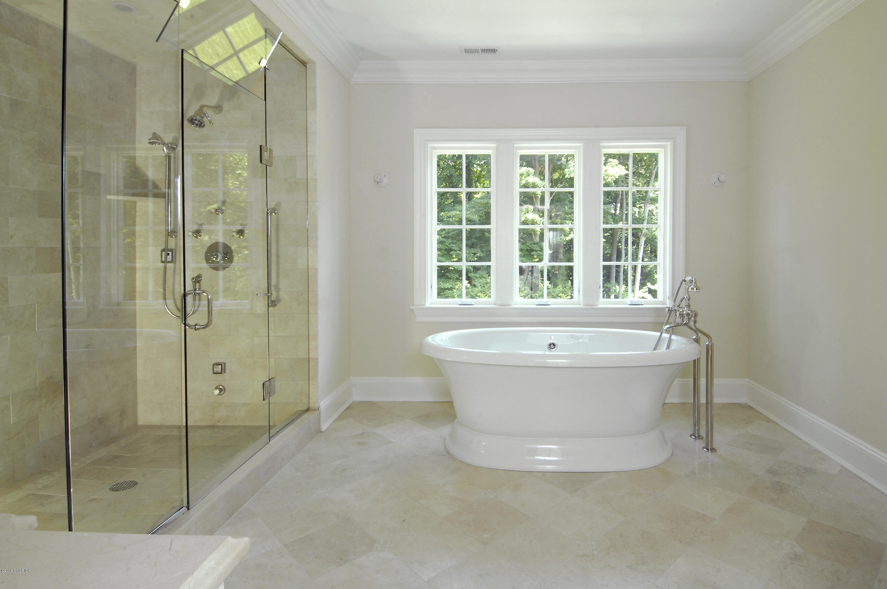 43 Burning Tree Road Greenwich, CT 06830 - Photo 16 of 24 a bathroom with a bathtub and a shower